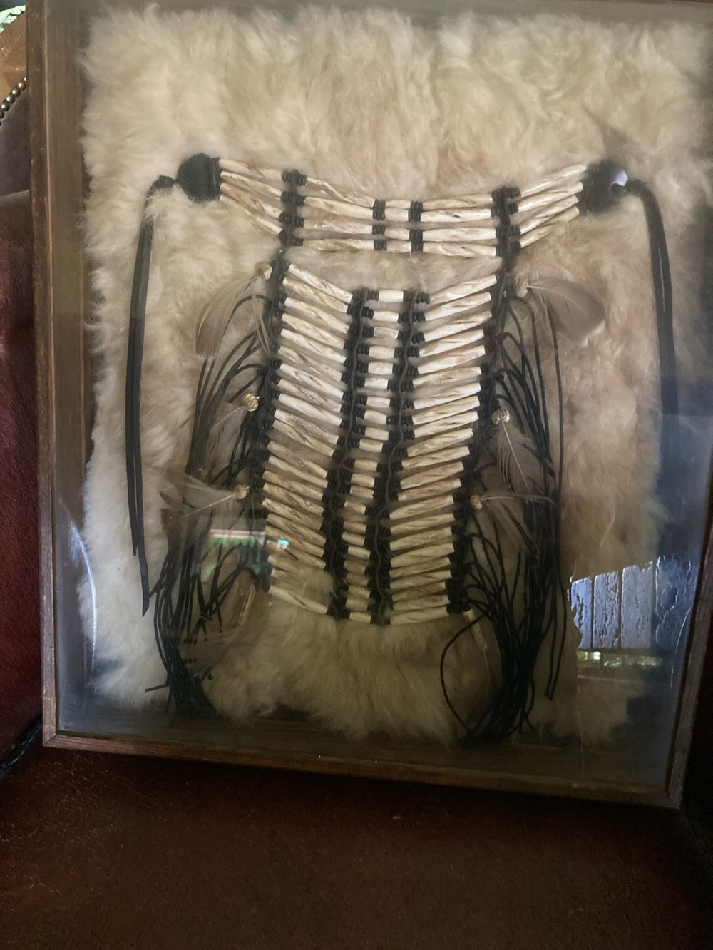 Shadow box framed Native American child’s breast plate
